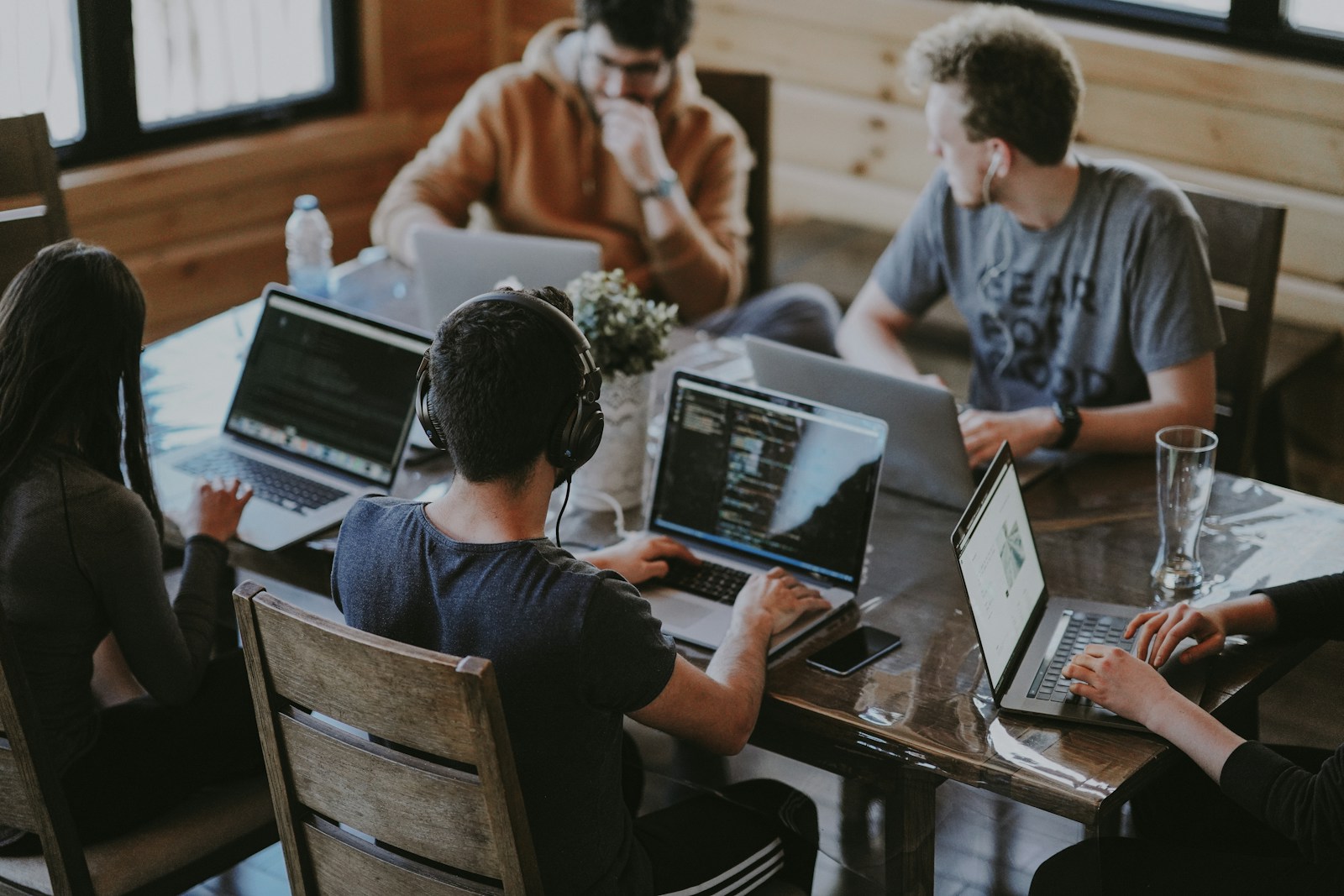 Diverse professionals collaborating in a modern office — teamwork and delivery